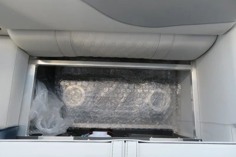 Slide: The Image of 2025 Avalon 2385 LSZ Versatile Rear Lounger storage compartment with bubble-wrapped contents. - 77