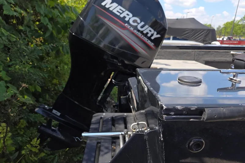 Slide: The Image of 2012 Tracker Targa V-18 boat with Mercury outboard motor, surrounded by greenery. - 5