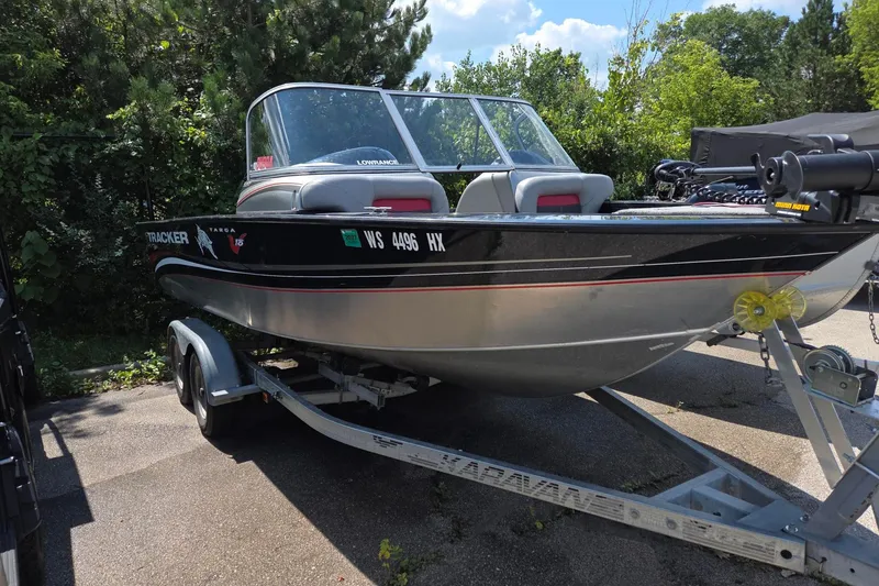 Slide: The Image of 2012 Tracker Targa V-18 boat on trailer, parked outdoors with trees in background. - 6