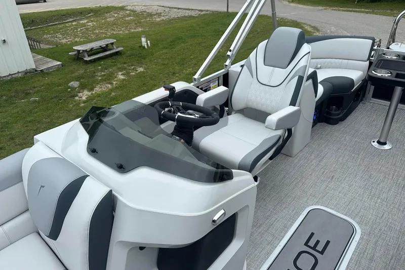 Slide: The Image of 2025 Tahoe 2185 boat interior with modern seating and steering console. - 15