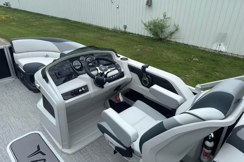 Slide: The Image of 2025 Tahoe 2185 boat interior with modern helm, steering wheel, and seating. - 17