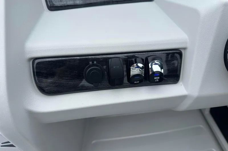 Slide: The Image of Control panel of 2025 Tahoe 2185 boat with switches for bilge and mood lights. - 19