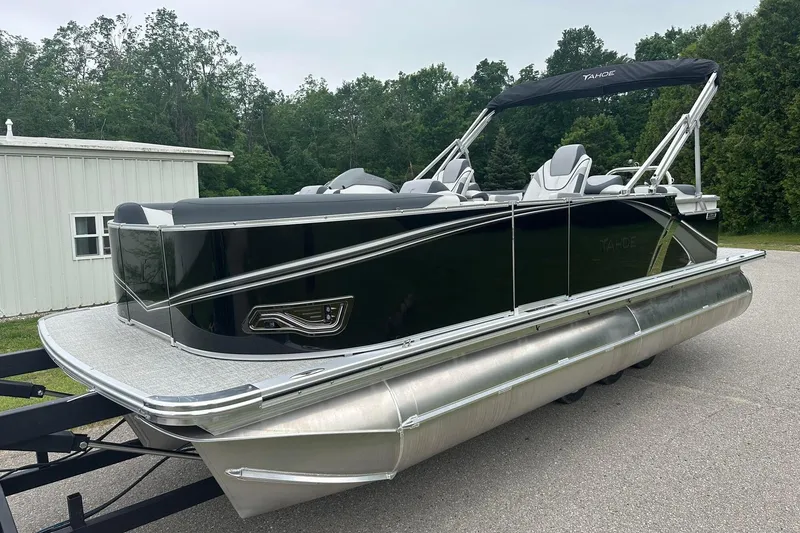 Slide: The Image of 2025 Tahoe 2185 pontoon boat with sleek black design and modern seating. - 2