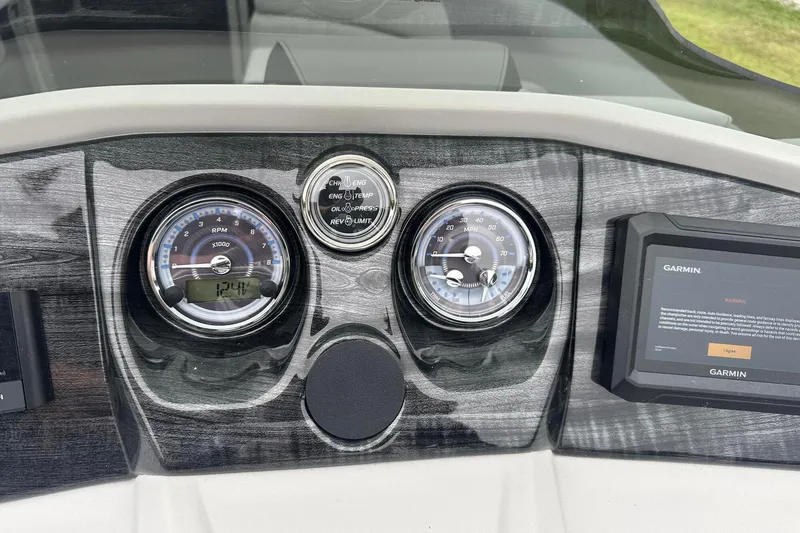 Slide: The Image of Dashboard of 2025 Tahoe 2185 boat with gauges and Garmin display. - 21