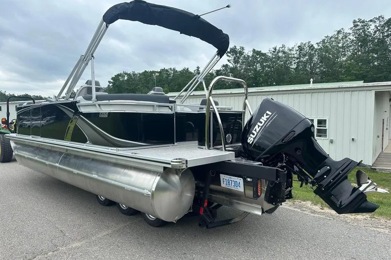 Slide: The Image of 2025 Tahoe 2185 pontoon boat with Suzuki outboard motor on a trailer. - 4