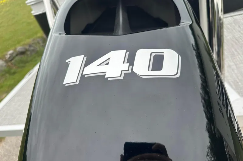 Slide: The Image of Close-up of a black Tahoe 2185 outboard motor with "140" decal, 2025 model. - 6