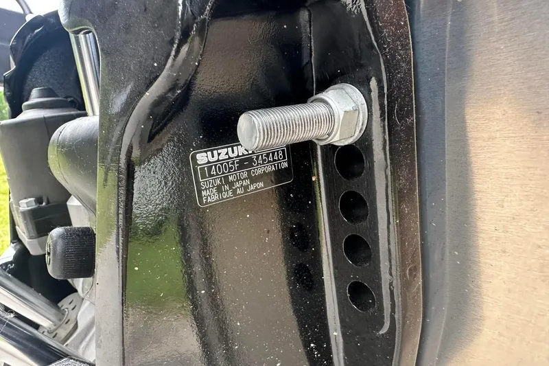 Slide: The Image of Close-up of a Suzuki motor part with serial number and bolt detail. - 7