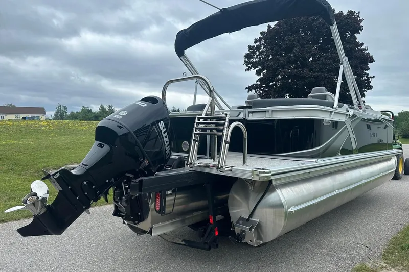 Slide: The Image of 2025 Tahoe 2185 pontoon boat with Suzuki outboard motor on a road. - 9