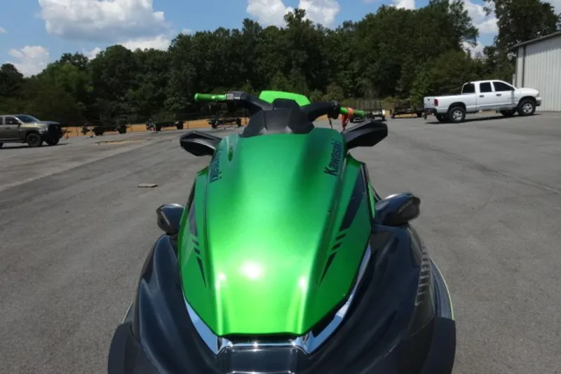 Slide: The Image of 2020 Kawasaki STX160 jet ski in vibrant green, parked outdoors. - 1