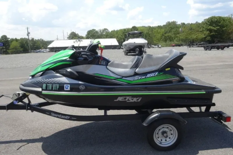 Slide: The Image of 2020 Kawasaki STX160 Jet Ski on trailer, parked outdoors. - 2