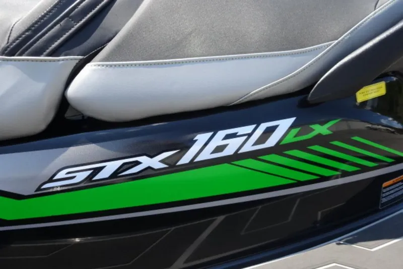 Slide: The Image of 2020 Kawasaki STX160 jet ski with green and black design details. - 4