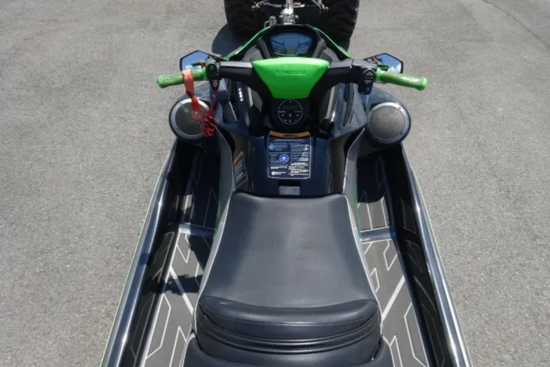 Slide: The Image of 2020 Kawasaki STX160 jet ski with green handlebars and sleek black seat design. - 5