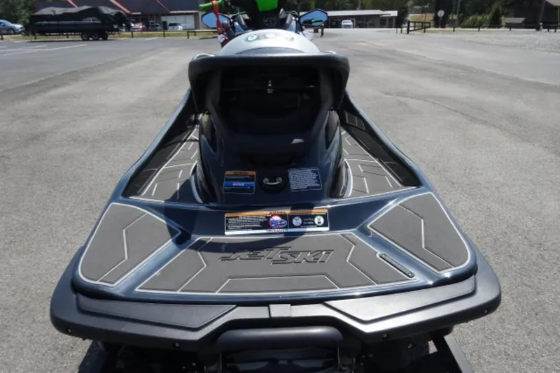 Slide: The Image of 2020 Kawasaki STX160 Jet Ski, rear view on pavement, showcasing sleek design. - 8