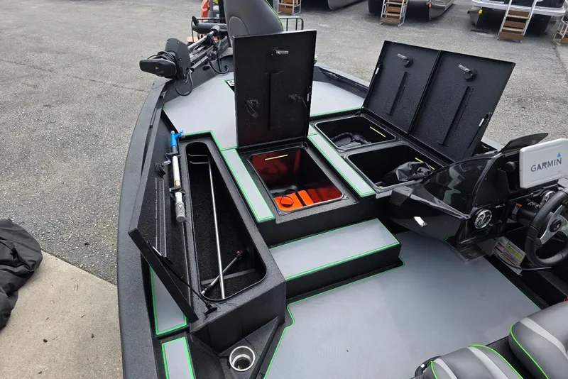 Slide: The Image of 2022 Xpress H18 Bass boat interior with storage compartments and Garmin electronics. - 10