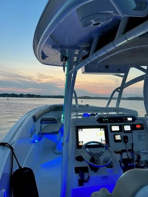 Slide: The Image of Sailfish 320 CC 2018 boat at sunset on calm waters. - 11