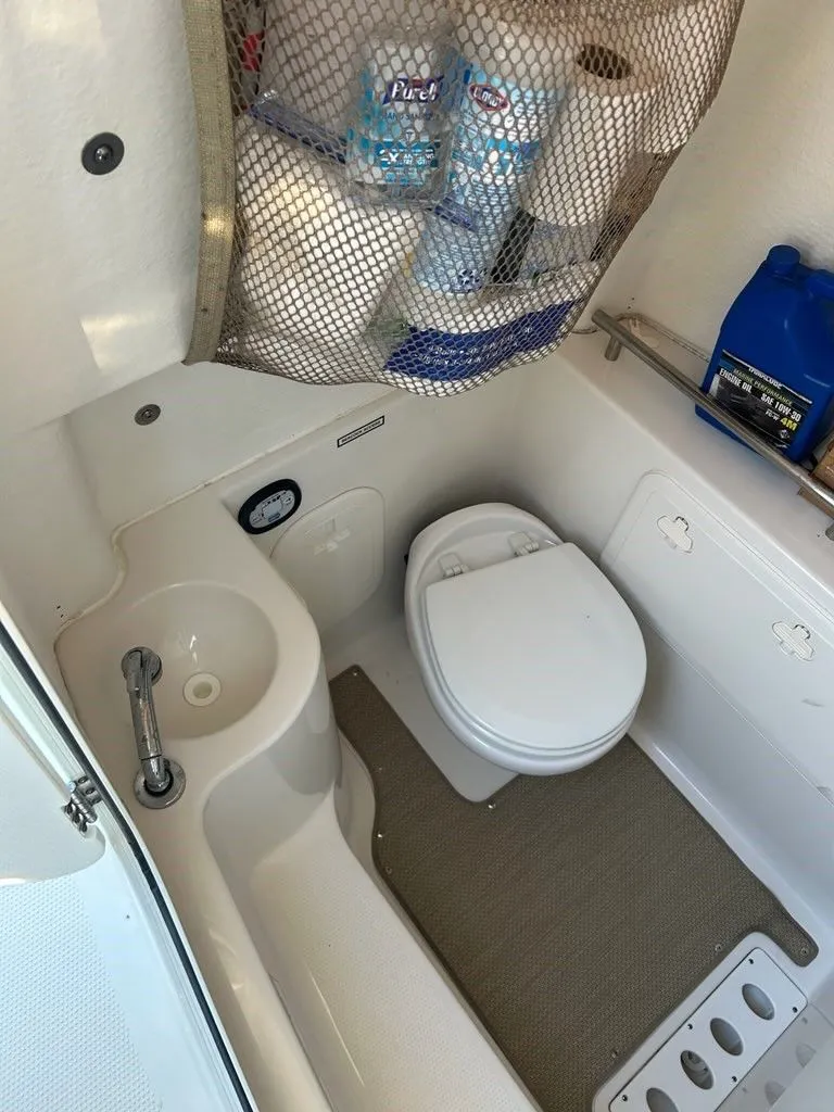 Slide: The Image of Interior of a 2018 Sailfish 320 CC with toilet and sink. - 13
