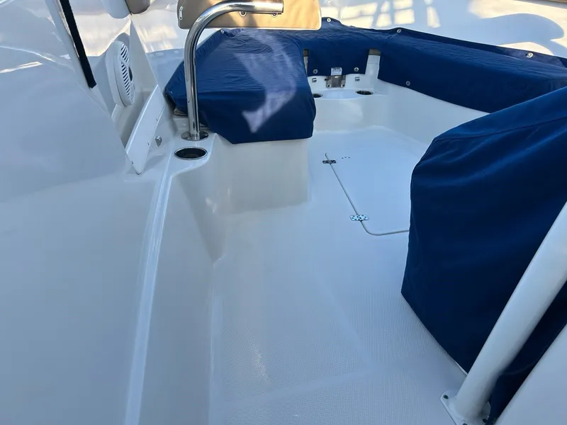 Slide: The Image of Interior of a 2018 Sailfish 320 CC boat with blue covers. - 8