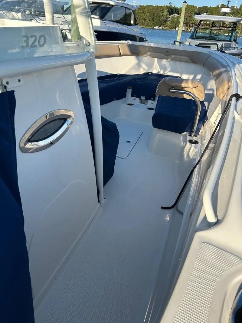 Slide: The Image of Interior view of a 2018 Sailfish 320 CC boat with blue seating. - 9