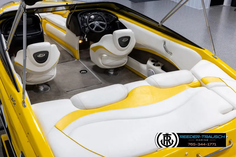 Slide: The Image of 2007 Crownline 21 SS boat interior with yellow and white seating, sleek design, and modern dashboard. - 11