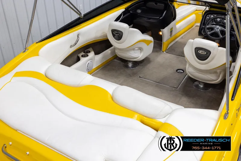 Slide: The Image of 2007 Crownline 21 SS boat interior with yellow and white seating, steering wheel, and controls. - 12