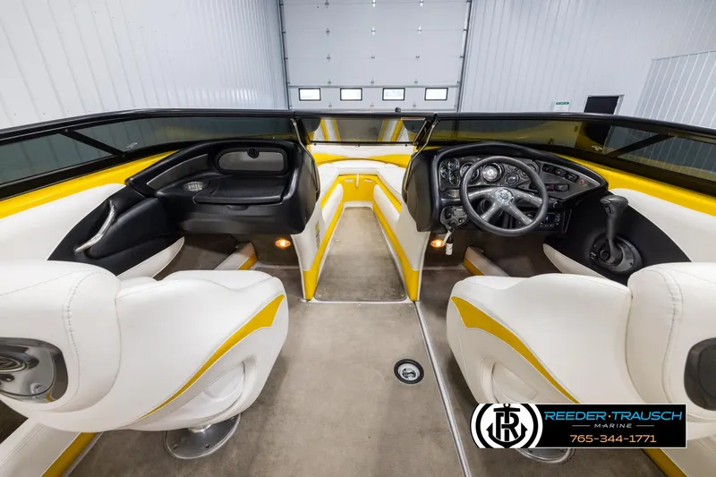 Slide: The Image of 2007 Crownline 21 SS boat interior with white and yellow seating, modern dashboard. - 14