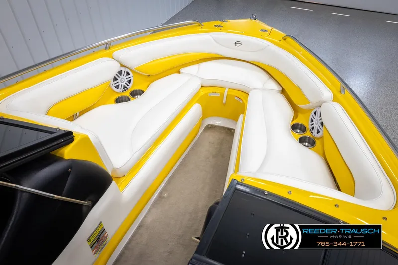 Slide: The Image of 2007 Crownline 21 SS boat interior with yellow and white seating, cup holders, and speakers. - 19