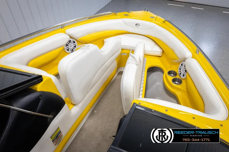 Slide: The Image of 2007 Crownline 21 SS boat interior with yellow and white seating, cup holders, and speakers. - 20