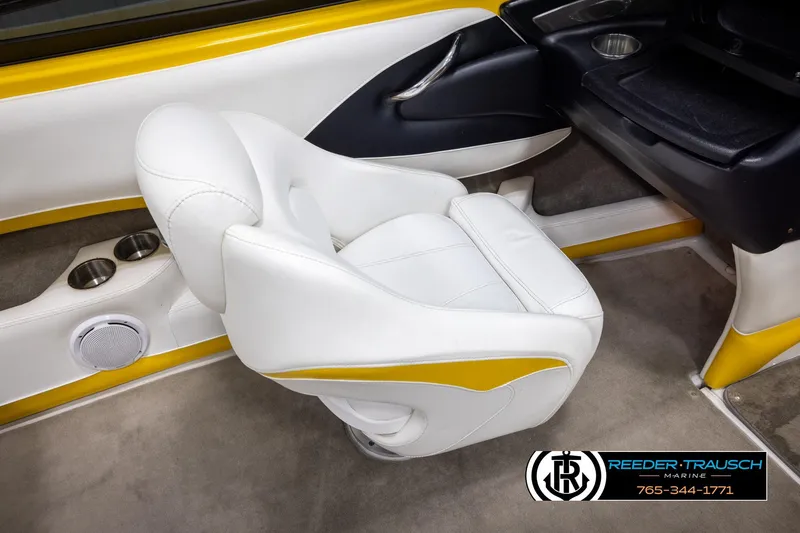 Slide: The Image of 2007 Crownline 21 SS boat interior with white and yellow seating, cup holders, and speaker. - 23