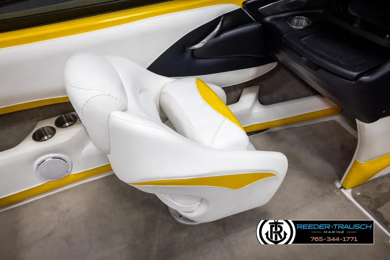Slide: The Image of 2007 Crownline 21 SS boat interior with white and yellow seating, cup holders, and speaker. - 24