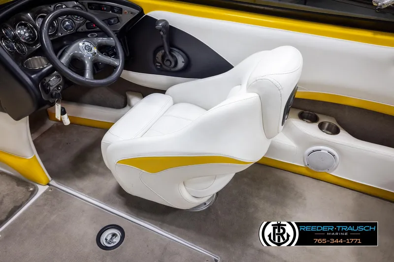 Slide: The Image of 2007 Crownline 21 SS boat interior with white and yellow seating, steering wheel, and dashboard. - 25