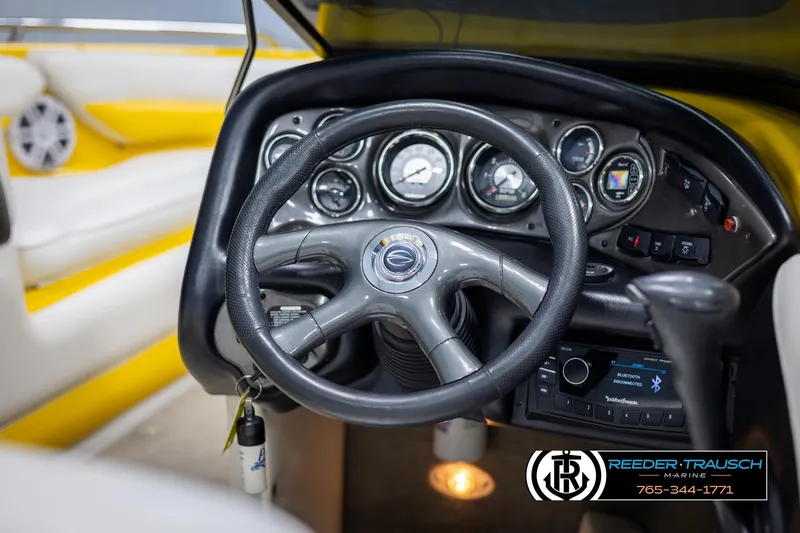 Slide: The Image of Steering wheel and dashboard of a 2007 Crownline 21 SS boat, featuring gauges and controls. - 27