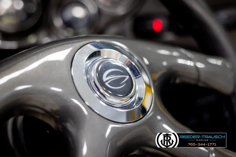 Slide: The Image of Steering wheel of 2007 Crownline 21 SS boat, featuring sleek design and logo. - 29