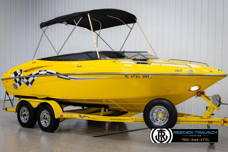 Slide: The Image of Bright yellow 2007 Crownline 21 SS boat with checkered flag design and black canopy. - 3