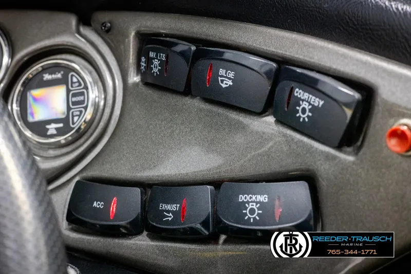 Slide: The Image of Dashboard controls of a 2007 Crownline 21 SS boat with various switches. - 34