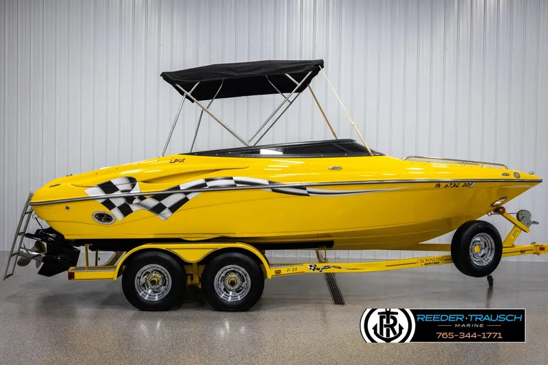 Slide: The Image of Yellow 2007 Crownline 21 SS boat with checkered flag design on trailer. - 5