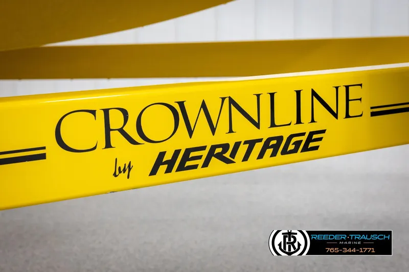 Slide: The Image of Yellow Crownline by Heritage trailer with Reeder-Trausch Marine logo and contact information. - 53