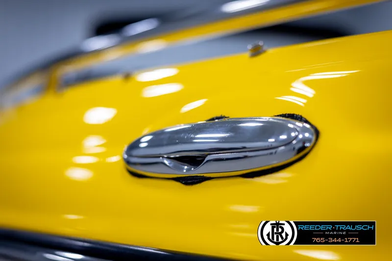 Slide: The Image of Close-up of a 2007 Crownline 21 SS boat's chrome handle on a yellow surface. - 55