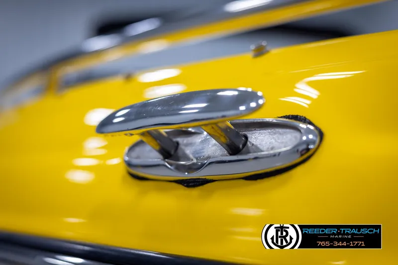 Slide: The Image of Close-up of a 2007 Crownline 21 SS boat cleat on a yellow surface. - 56