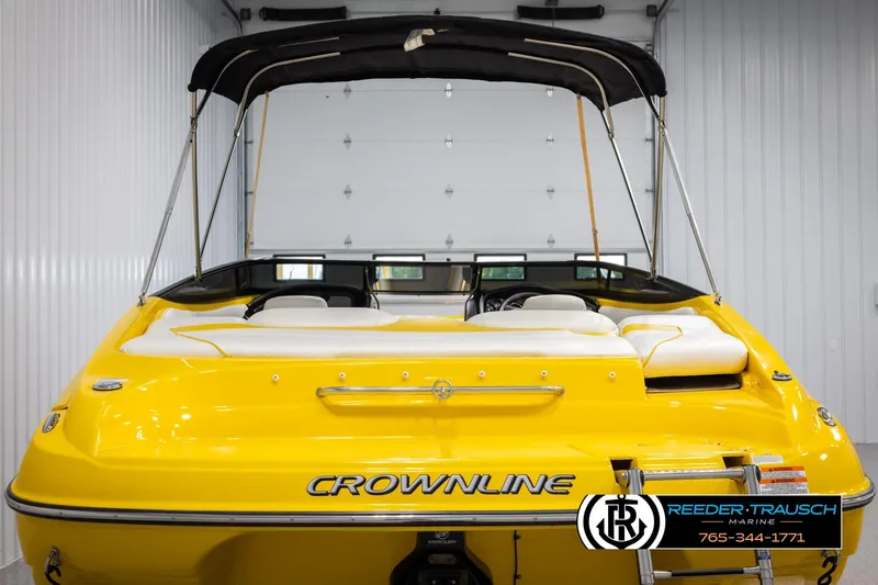 Slide: The Image of Yellow 2007 Crownline 21 SS boat with canopy in indoor storage. - 7