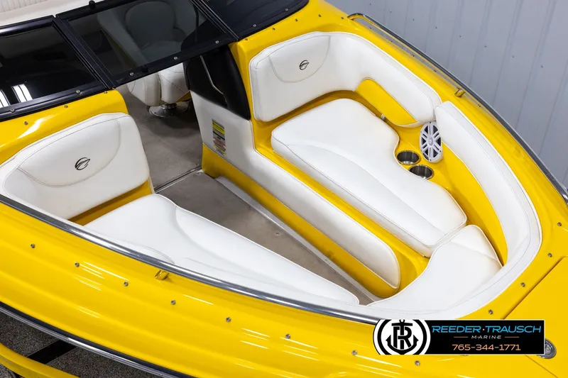 Slide: The Image of 2007 Crownline 21 SS boat interior with yellow and white seating, featuring cup holders and speakers. - 9