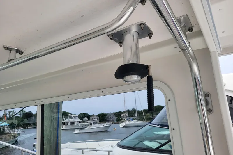 Slide: The Image of Interior view of 2023 Steiger Craft 31 Fisherman boat with metal fixtures and marina background. - 10