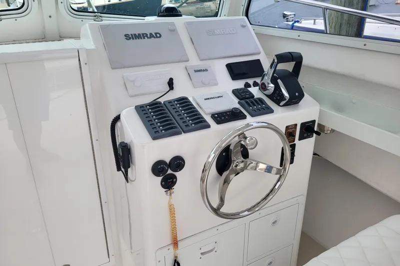 Slide: The Image of 2023 Steiger Craft 31 Fisherman helm with Simrad electronics and steering wheel. - 11