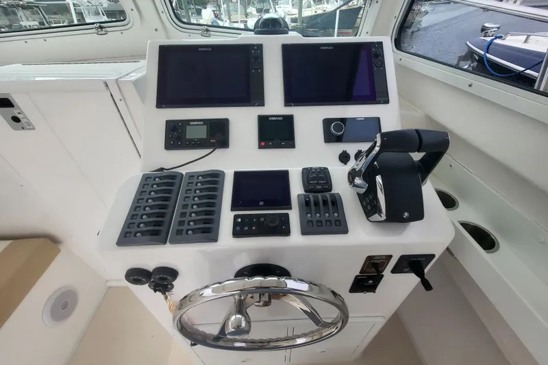 Slide: The Image of 2023 Steiger Craft 31 Fisherman helm with advanced navigation controls and dual Simrad displays. - 12