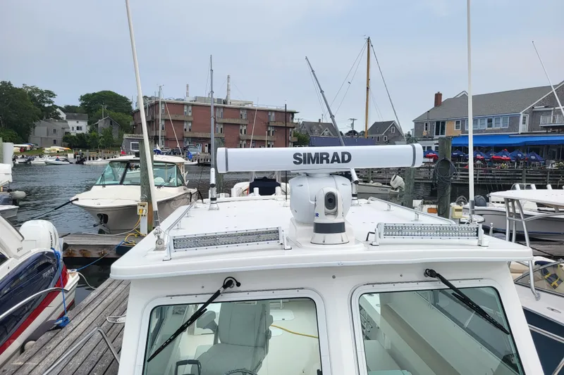 Slide: The Image of 2023 Steiger Craft 31 Fisherman docked, featuring Simrad radar system. - 16