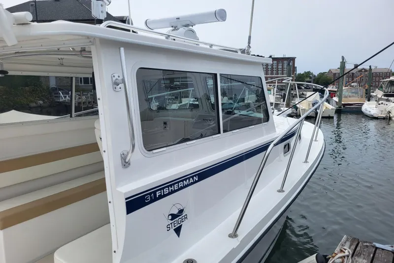 Slide: The Image of 2023 Steiger Craft 31 Fisherman boat docked in a marina. - 19
