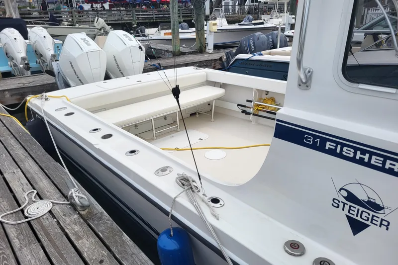 Slide: The Image of 2023 Steiger Craft 31 Fisherman boat docked with outboard engines. - 22