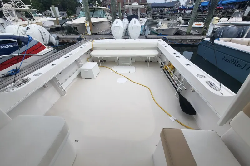 Slide: The Image of 2023 Steiger Craft 31 Fisherman boat interior at marina, showcasing spacious deck and seating. - 23