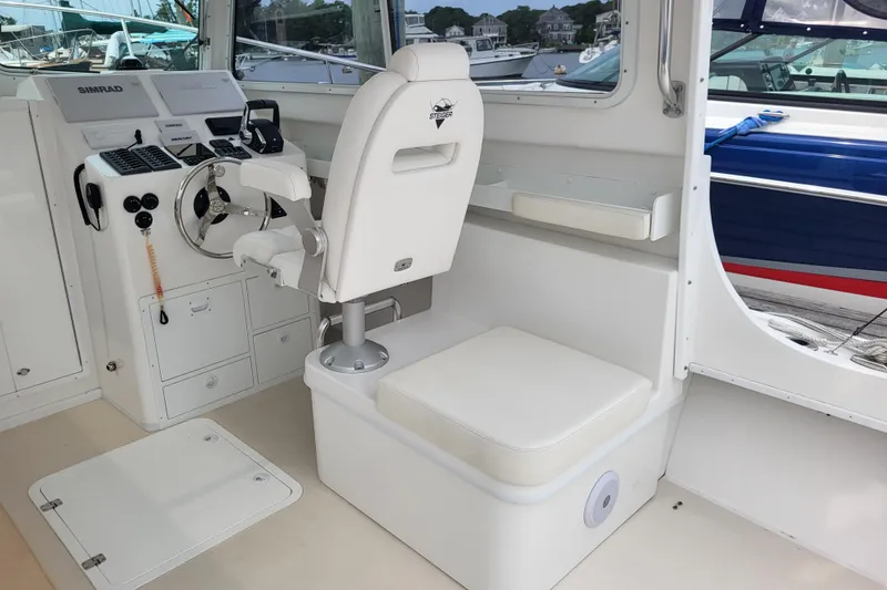 Slide: The Image of 2023 Steiger Craft 31 Fisherman boat interior with helm, steering wheel, and seating. - 6