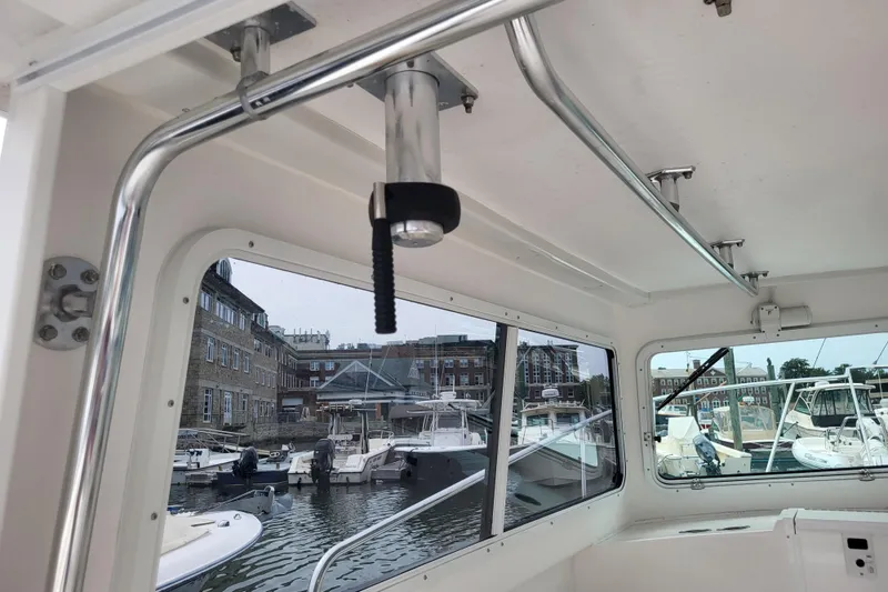 Slide: The Image of Interior view of 2023 Steiger Craft 31 Fisherman boat in a marina setting. - 9