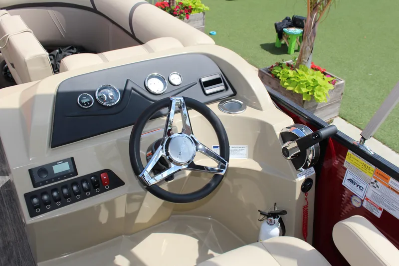 Slide: The Image of 2023 Crest 220 SLS Classic boat dashboard with steering wheel and control panel. - 3